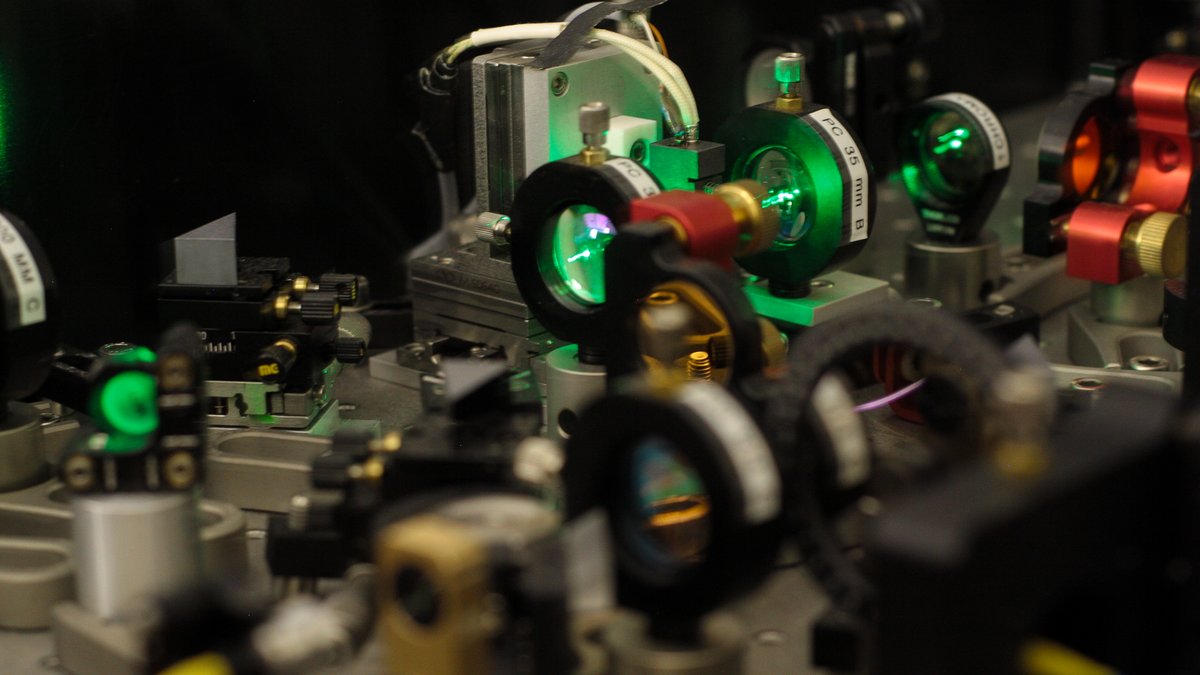 A laser beam is guided through lenses of an optical assembly